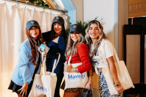 Denver influencers with Mavely tote bags and hats at creator meetup