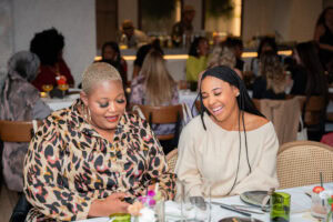 Two influencers share a laugh at meetup