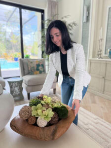 Melissa adjusts a table centerpiece for a content creation session with Christina.