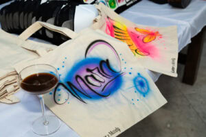 Custom airbrushed tote bags from Cocktails & Collabs creator event in Miami