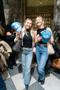Two creator meetup attendees show off their custom trucker hats