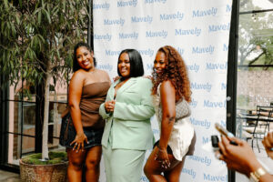 Creators pose at Mavely influencer event.