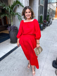 Jen Taylor, a creator who switched to Mavely from LTK, models a red jumpsuit.