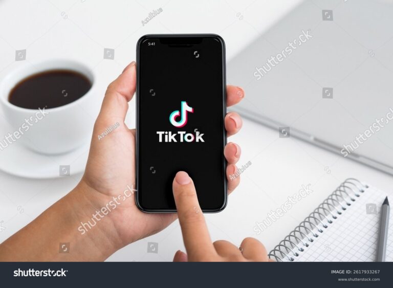 Hand holding TikTok app; affiliate marketing with TikTok
