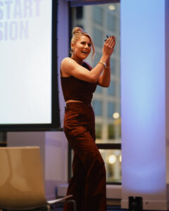 Krista Williams exits the stage following her Swipe Up 2025 keynote.