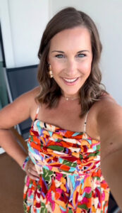 Fashion creator Kate Wilkes models a vibrant print sundress.